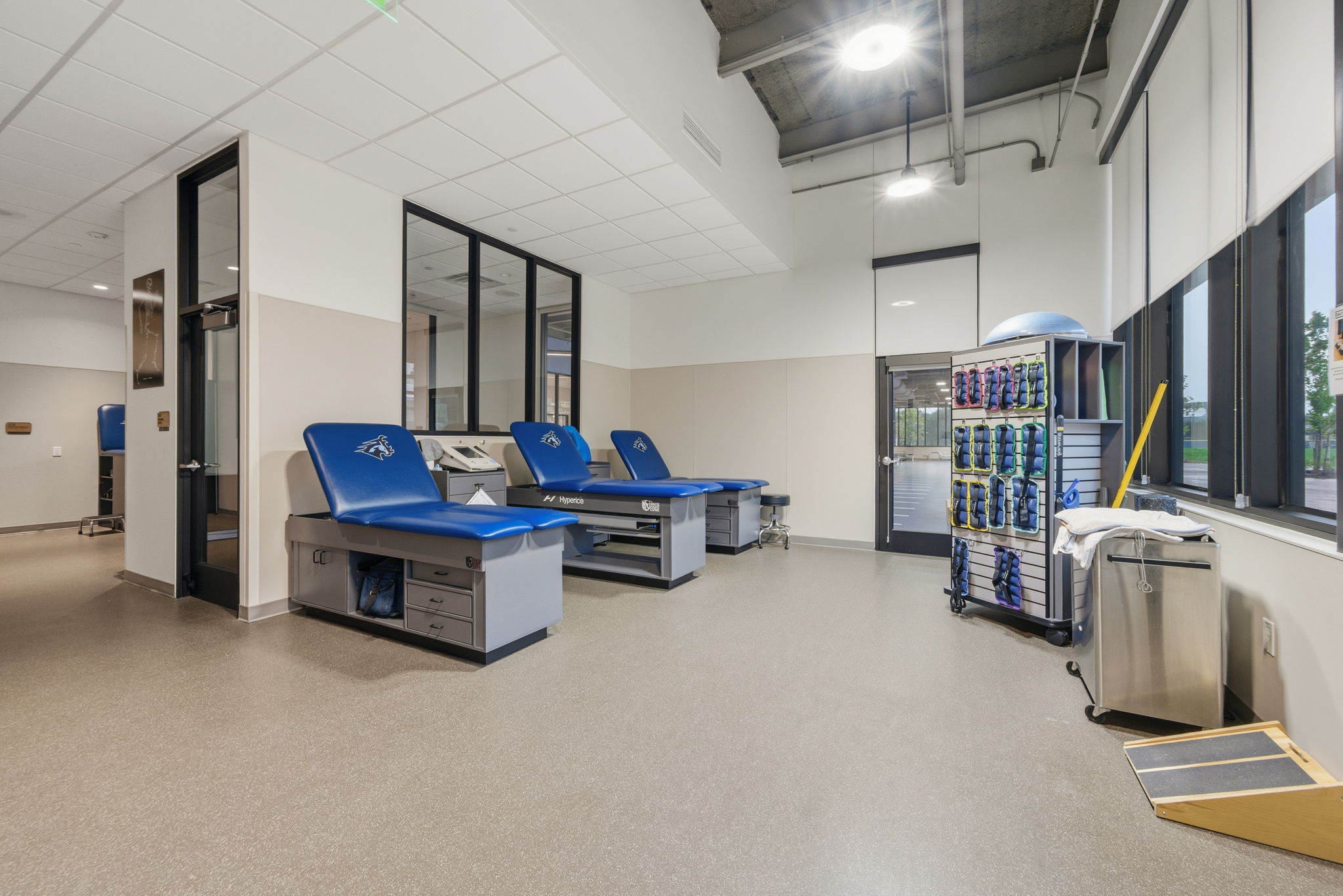 Photo of trainer's room. Medical tables line the wall.