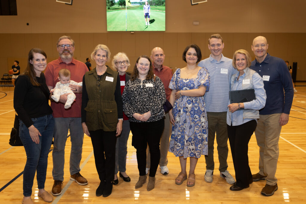 Johnson's family stands together and smiles.