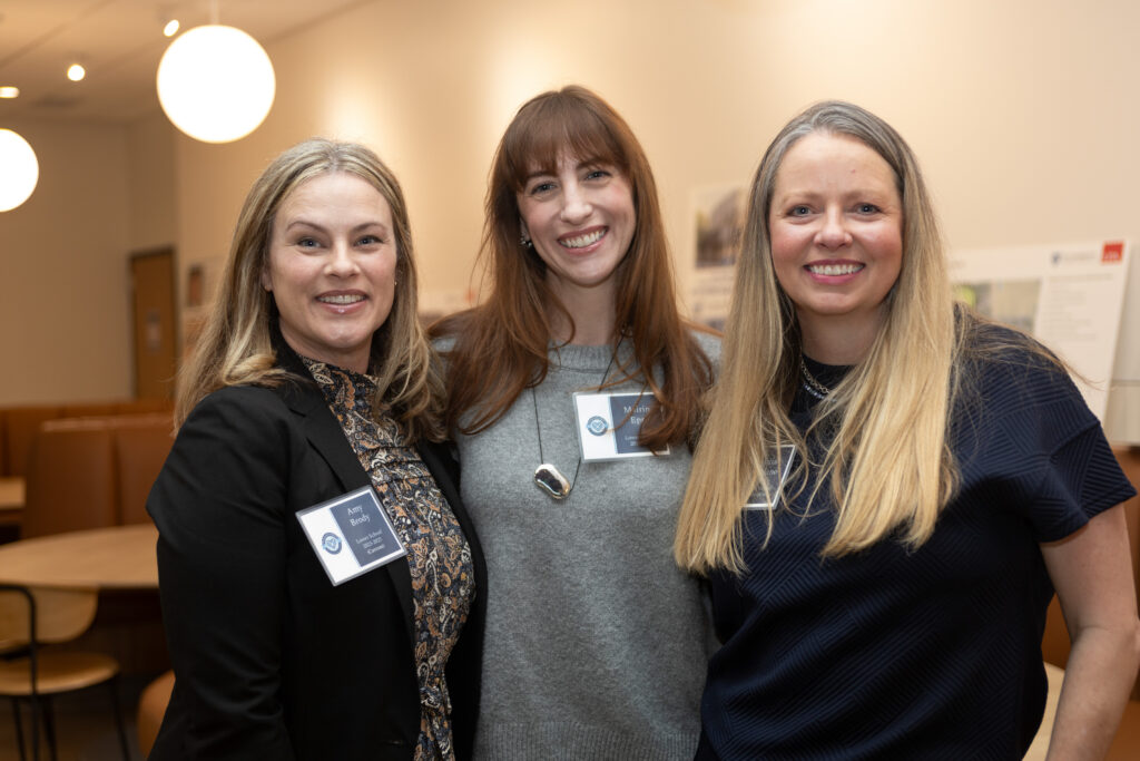 Three PA members stand next to each other and smile.