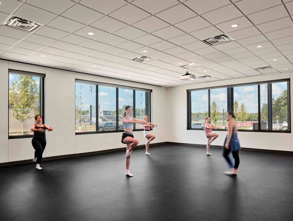 Students practice turns in the dance studio.