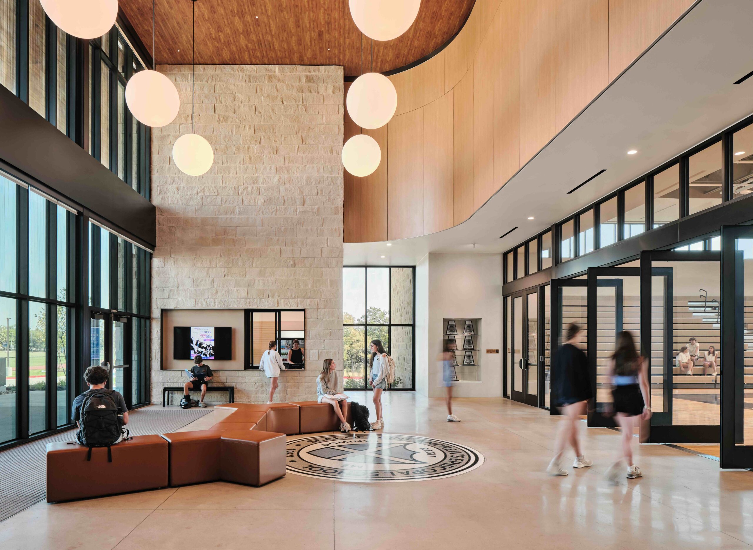 Students sit and walk throughout the front lobby of Highlander Hall.